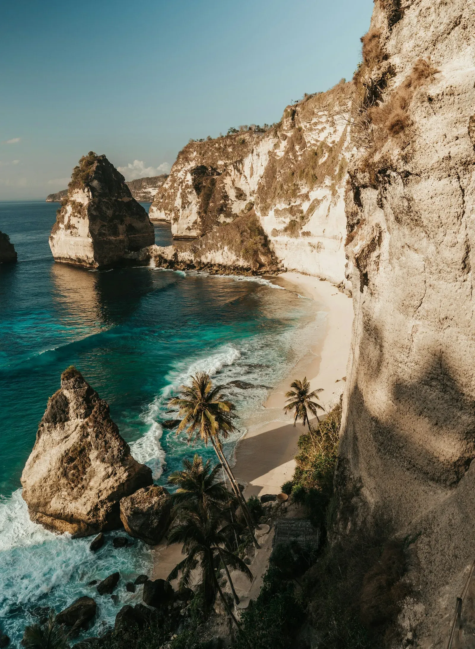 Turquoise water meets the limestone cliffs and sandy beach of Bali
