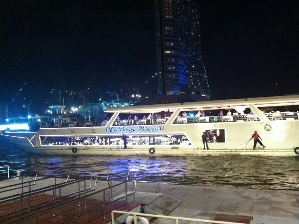 An illuminated dinner-cruise boat on the Chao Phraya River in Bangkok
